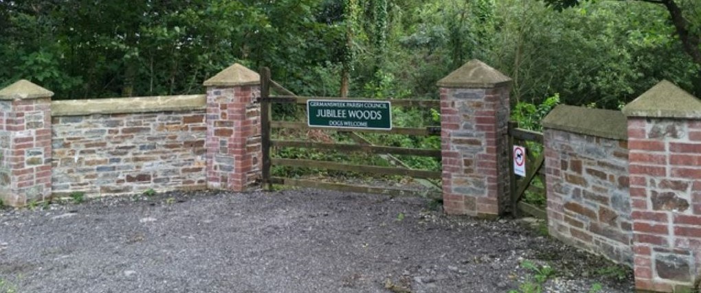 Photo of brick gate with wooded vehicle gate and Germansweek Parish Council sign.